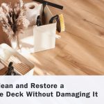 Cleaning supplies placed on wood-look composite decking demonstrating safe composite deck cleaning and maintenance techniques.