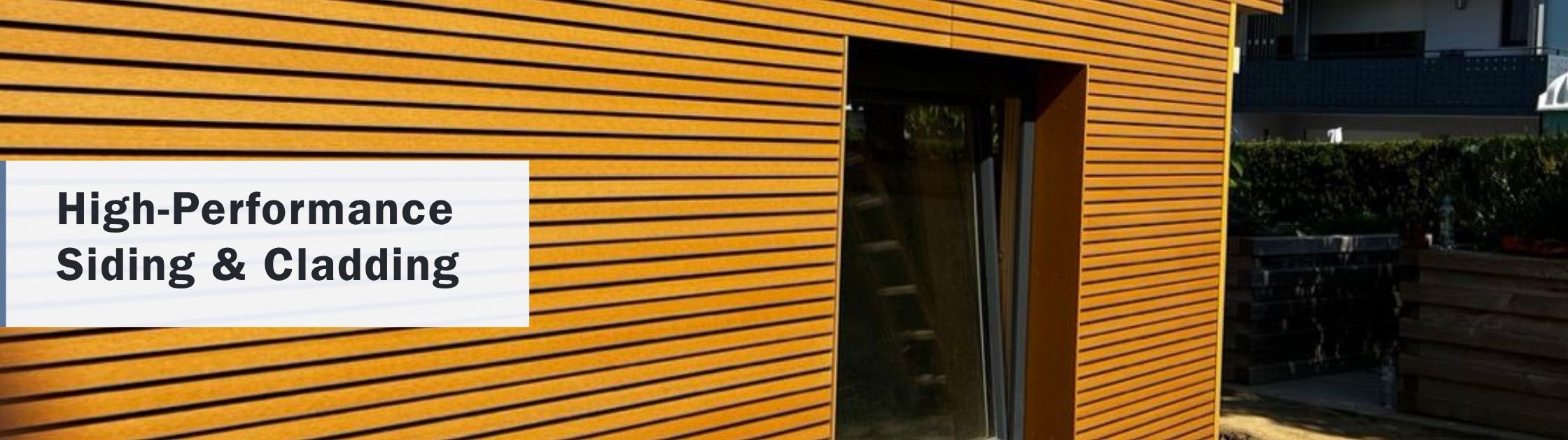 Contemporary building exterior featuring high-performance Novano composite siding and cladding with a natural wood appearance.